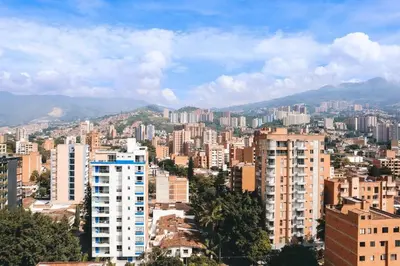 a city with tall buildings and mountains in the background at Inviting Stadio Suite Rosa Negra in Medellín