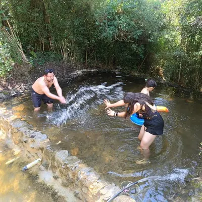 a group of people standing in the water at Cabañas - 5 Continentes Cerca Metrocable ARVI in Guarne