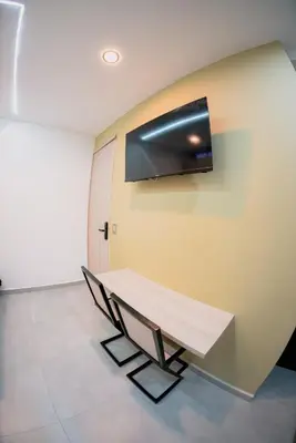 a room with a table and a tv on the wall at Live the Comuna 13 experience in Medellín INT 304 in Medellín
