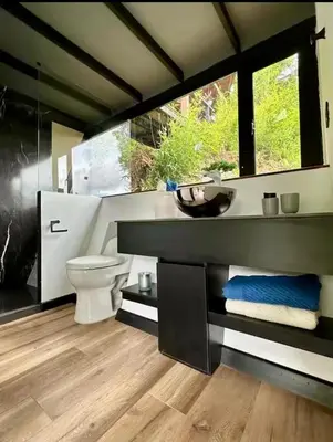 a bathroom with a toilet and a sink at Cabaña Del Lago - Cerca Metrocable ARVI in Guarne