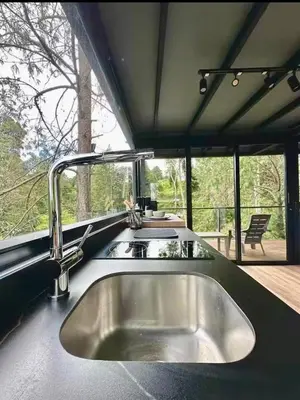 a kitchen with a sink and a large window at Cabaña Del Lago - Cerca Metrocable ARVI in Guarne