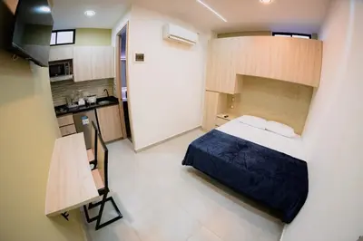 a small room with a bed and a kitchen at vive la experiencia comuna 13 Medellín INT 304 in Medellín