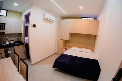a small room with a bed and a kitchen at vive la experiencia comuna 13 Medellín INT 304 in Medellín