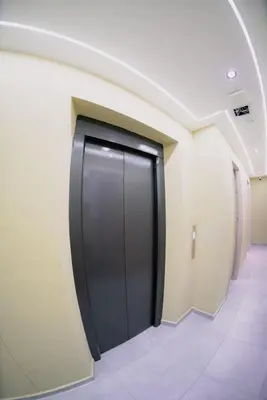 a hallway with a black door in a building at vive la experiencia comuna 13 Medellín INT 304 in Medellín