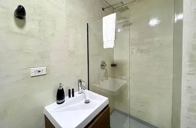 a white bathroom with a sink and a shower at 43 Laureles Life I Modern Loft and Excellent Location in Medellín
