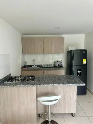 a kitchen with a counter top and a black refrigerator at CENTRO historico y CC FUNDADORES in Manizales