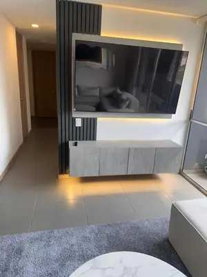 a living room with a large tv on the wall at Apartamento en Medellín poblado in Medellín