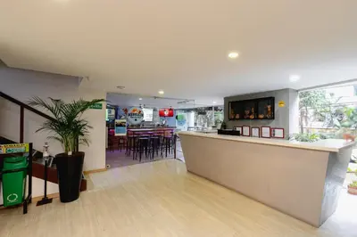 a restaurant with a counter and a bar in a room at Lovely one bedroom condo in beautiful Laureles in Medellín