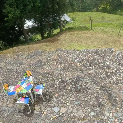 two chairs sitting on top of a rocky ground at HOSTAL - COLIVING - Cerca MetroCable ARVI in Guarne