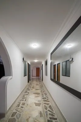 a corridor with a tile floor in a hallway at Your home away from home in Medellín