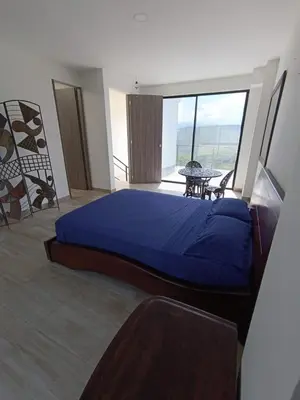 a bedroom with a large blue bed and a balcony at Villa Antonia in Santagueda