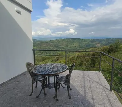 a table and chairs on a balcony with a view at Villa Antonia in Santagueda