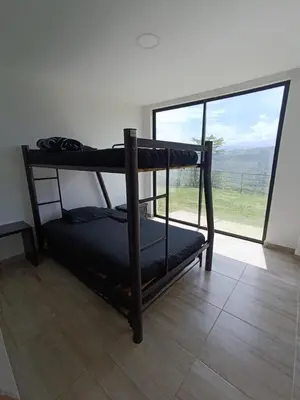 two bunk beds in a room with a large window at Villa Antonia in Santagueda