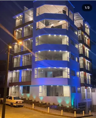 a blue building with a car parked in front of it at Vancouver 102 in Villamaría