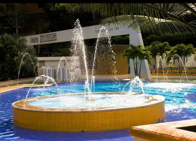 a fountain in the middle of a swimming pool at Cabaña ciudadela premium San Jerónimo in San Jerónimo
