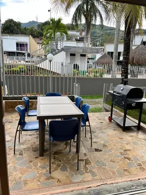 a patio with a table and chairs and a grill at Cabaña ciudadela premium San Jerónimo in San Jerónimo
