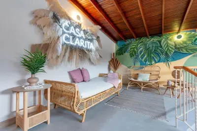 a room with a wicker chair and a sign on the wall at Cozy Apt 4 -Laureles -AC- Smart Lock in Medellín