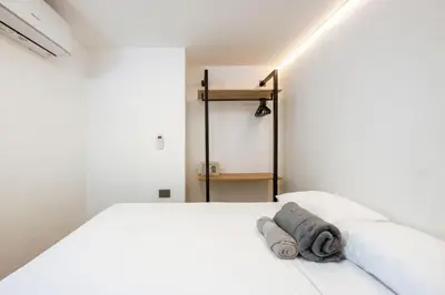 a bedroom with a white bed with a towel on it at M301 Poblado Apt close to lleras park jacuzzi AC in Medellín