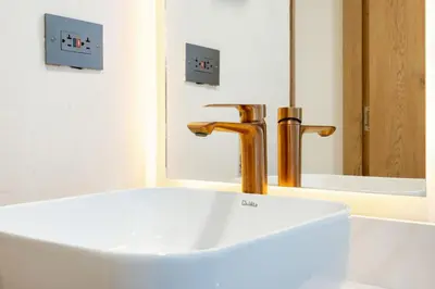 a bathroom with a white sink and a faucet at M501 Poblado Apt close to lleras park jacuzzi AC in Medellín