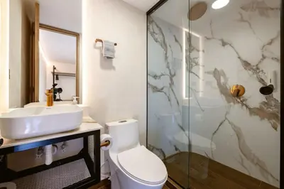 a bathroom with a toilet and a sink and a shower at M501 Poblado Apt close to lleras park jacuzzi AC in Medellín