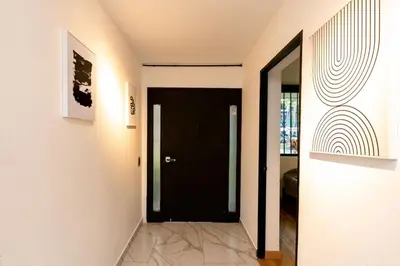 a hallway with a black door in a house at L1 7BR Laureles House rooftop jacuzzi AC in Medellín