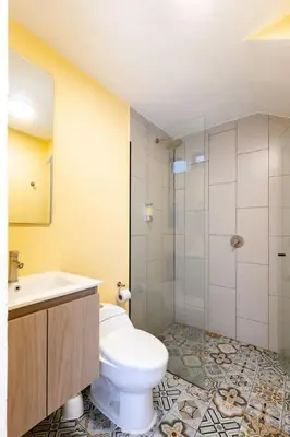 a bathroom with a toilet and a sink and a shower at L3 9BR Laureles House Rooftop 2 Jacuzzis AC in Medellín