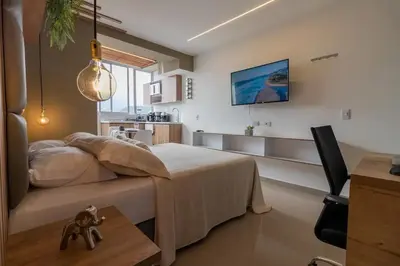 a bedroom with a bed and a table in a room at Apartasuite Stay & Relax Itagui in Itagüí