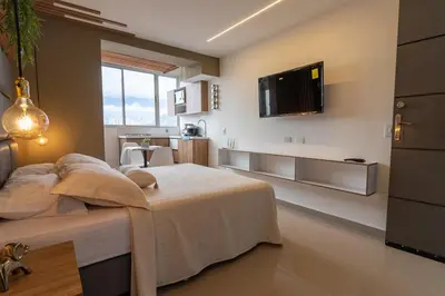a bedroom with a bed and a tv on the wall at Apartasuite Stay & Relax Itagui in Itagüí