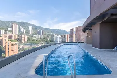 a swimming pool on top of a building with a city at Class Suites 502 - Modern Tranquility/Priv Balcony in El Poblado