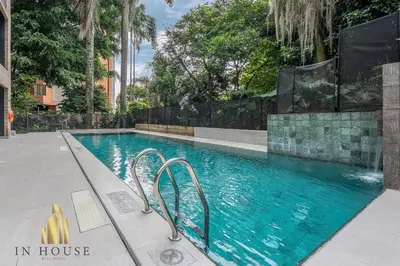 a swimming pool with blue water in a building at Morph 1002 - Luxe apt in Poblado/AC/BBQ in El Poblado