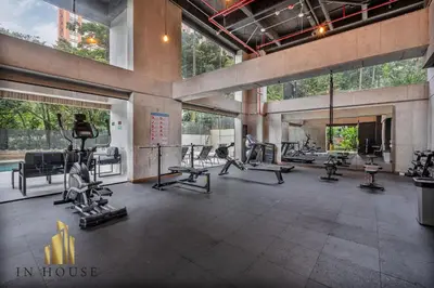 a gym with treadmills and machines in a building at Morph 201 - High ceilings & modern apt/BBQ in El Poblado