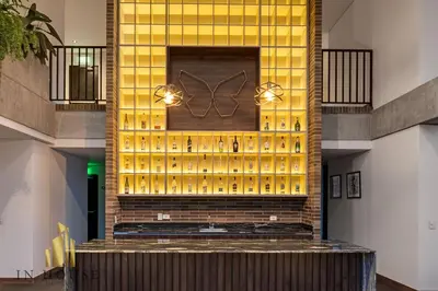 a lobby with a wall of wine bottles at Morph 302 - Modern apt high ceilings BBQ/Jacuzzi in El Poblado