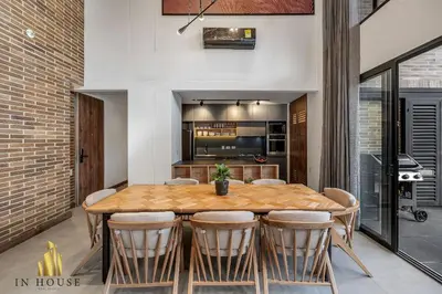 a kitchen and dining room with a wooden table and chairs at Morph 401 - Modern apt High Ceilings BBQ/Jacuzzi in El Poblado