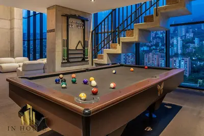 a pool table in a room with a staircase at Morph 501 - Spacious Cozy Apt Poblado/BBQ/Jacuzzi in El Poblado