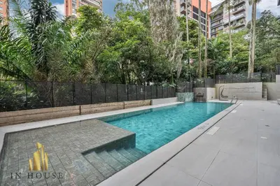 an empty swimming pool in a building with trees at Morph 501 - Spacious Cozy Apt Poblado/BBQ/Jacuzzi in El Poblado