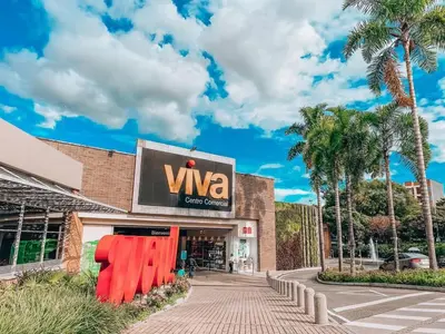 a building with a sign for a viva store at Laureles Apt-Big Windows-Smart lock- AC in Medellín