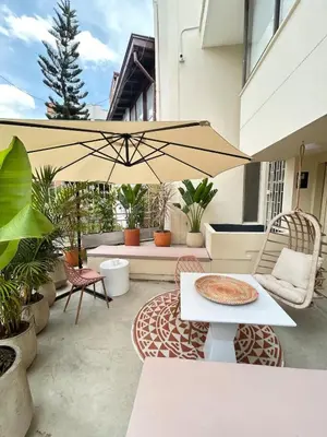 a patio with a table and an umbrella at Laureles Apt-Eco-Smart Locks-AC-Super Location in Medellín