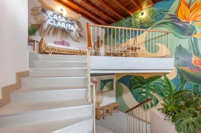 a staircase in a house with a mural at Spacious Laureles Apt-Smart Lock-Queen Bed-AC in Medellín