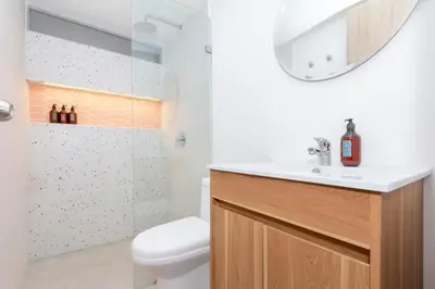a bathroom with a toilet and a sink and a shower at Spacious Apt -Laureles -AC -Smart Lock- WiFi in Medellín