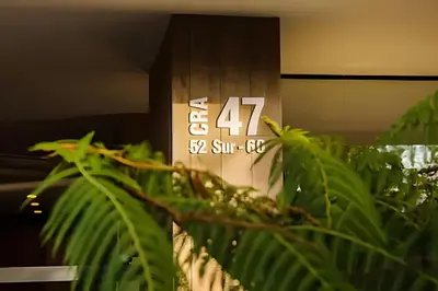 a sign in a room with green plants at Class 48 apto. 1603 - Sophisticated apt/panoramic views in Sabaneta