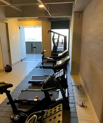 a row of treadmills in a gym with machines at Class 48 apto. 1603 - Sophisticated apt/panoramic views in Sabaneta