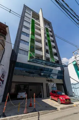 a red car parked in front of a building at ApartaSuite Central Luxe in Itagüí