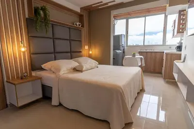 a bedroom with a large bed in a kitchen at ApartaSuite Central Luxe in Itagüí