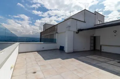 a building on top of a building with a roof at ApartaSuite Central Luxe in Itagüí