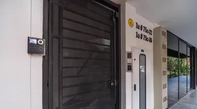 a black door on the side of a building at Coffee Spring Studio Medellin in Medellín