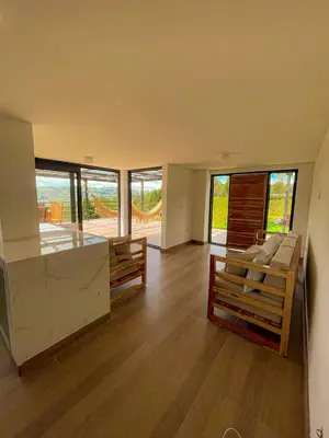 a living room with wooden floors and large windows at Apartamento en Guarne-Antioquia in Guarne