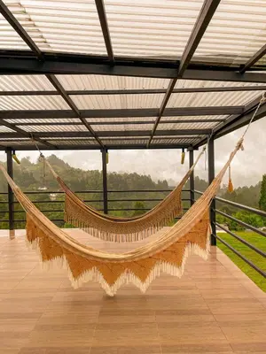 a hammock in a building with a view of a field at Apartamento en Guarne-Antioquia in Guarne