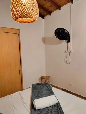 a room with a bed with a chair and a lamp at Ambiente natural y amplio, con vista panorámica de Medellín 501 in Medellín