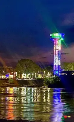 a control tower lit up in blue and green at night at Alojamiento Sol Naciente in Puerto Triunfo