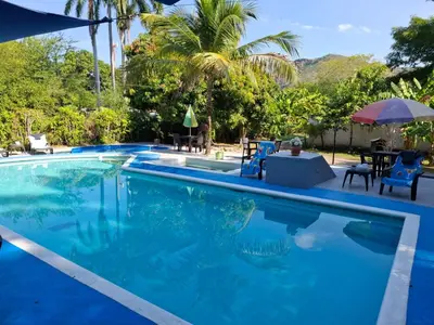 a swimming pool with blue water in a resort at family home in Honda